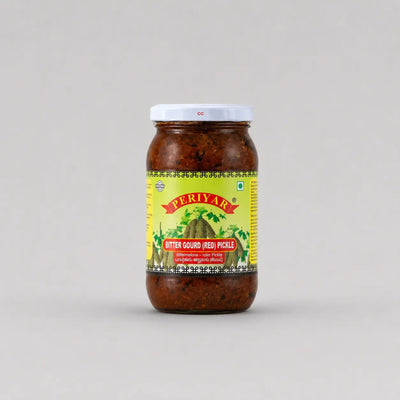 Jar of Periyar Bitter Gourd Pickle on a gray background