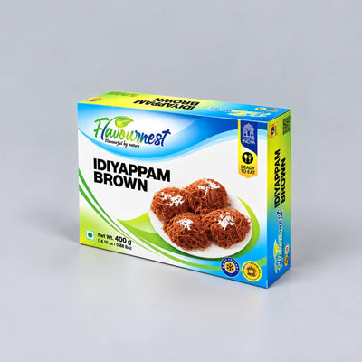A box of Flavournest Idiyappam Brown (Chivda) on a light gray background. The packaging is blue, white, and green, featuring an image of four brown idiyappam balls on a white plate.