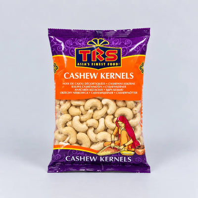 A package of TRS Cashew Kernels, featuring a purple and orange bag with a clear window showing the light tan cashews inside, set against a neutral light gray background.