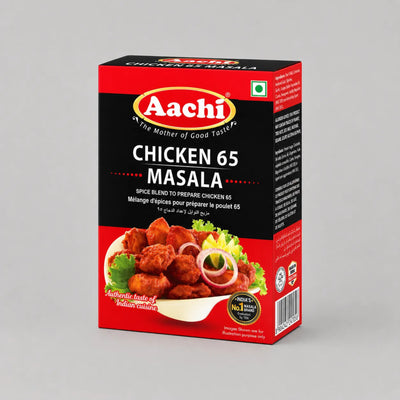 A rectangular box of Aachi Chicken 65 Masala spice blend, featuring a red and black design with a photo of cooked chicken pieces on the front, photographed on a light gray background.