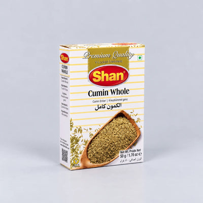 A box of Shan Cumin Whole spice powder, featuring a white and yellow striped design with a red Shan logo and an illustration of the cumin seeds in a wooden spoon.