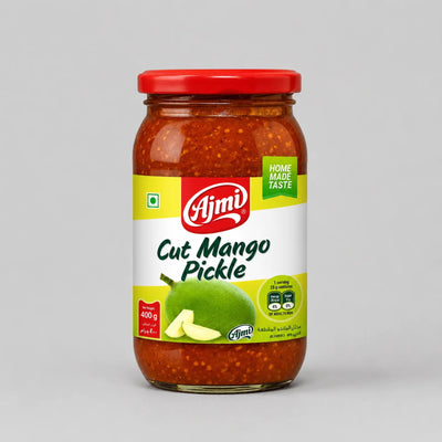A glass jar of Ajmi Cut Mango Pickle with a red lid and a white label featuring a green mango illustration, set against a neutral gray background.