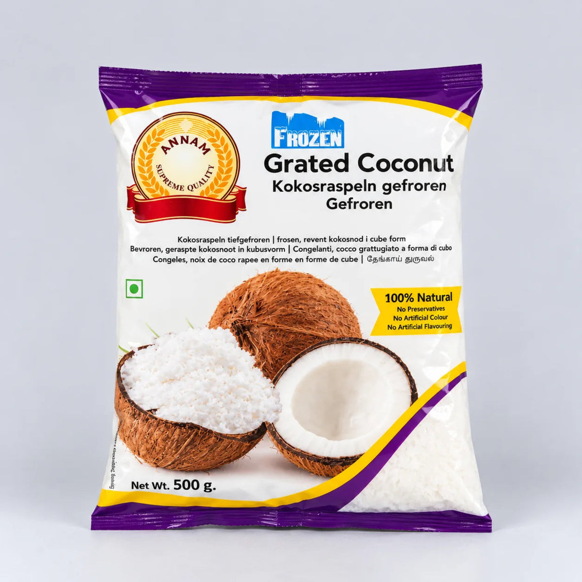A 500g bag of Annam Frozen Grated Coconut (Kokosraspeln gefroren) on a light gray background. The packaging is white with purple and yellow accents, featuring a gold brand seal and an illustration of a halved coconut showing white grated coconut inside.