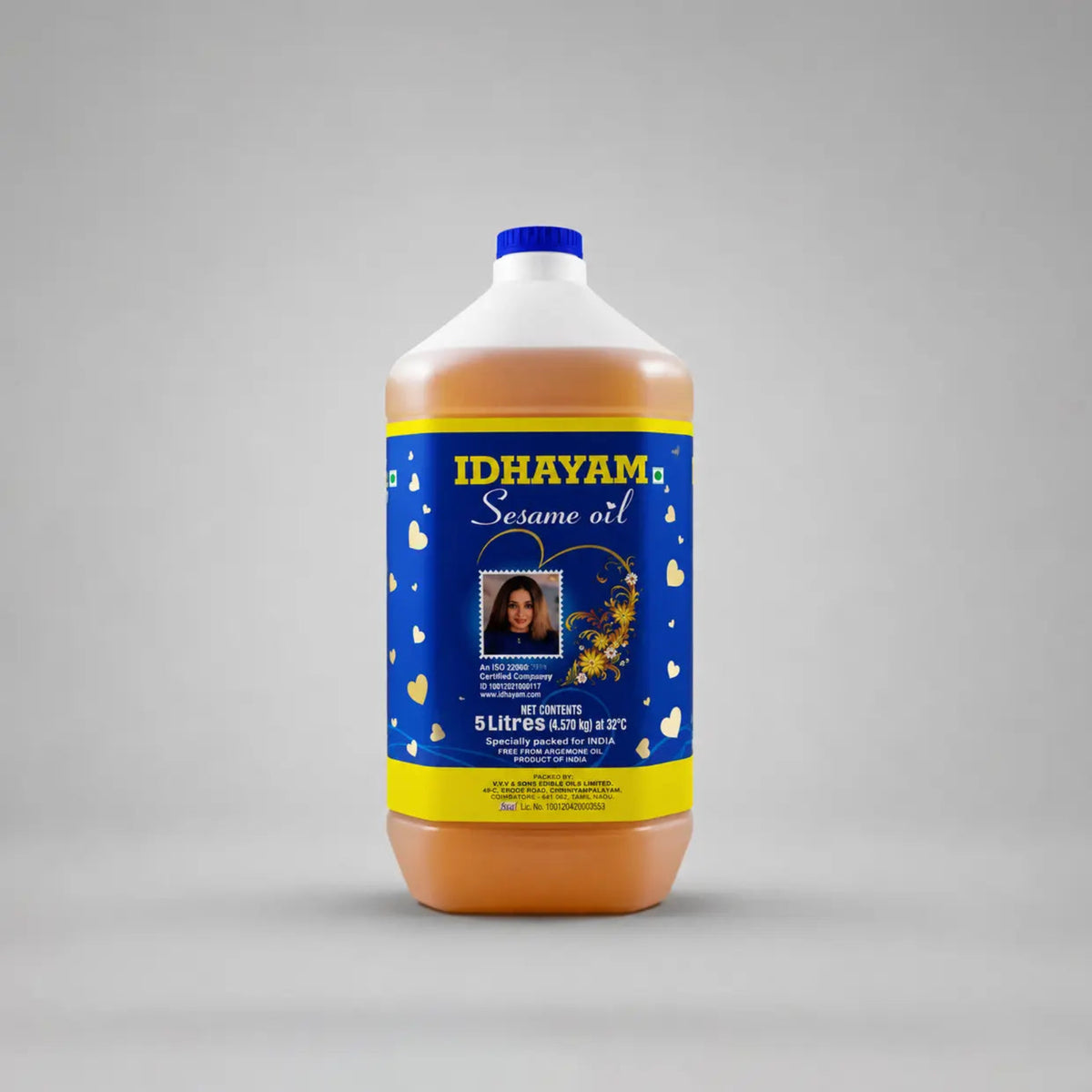 Idhayam Sesame oil bottle with blue and yellow label on a gray background