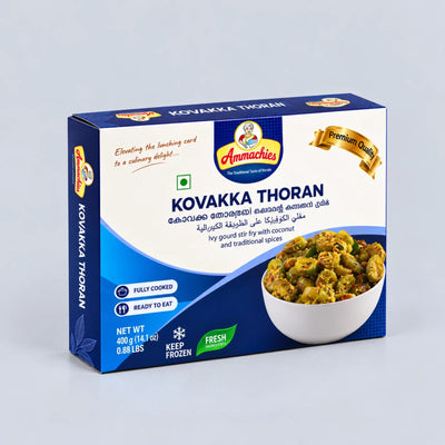 A box of Annachies Kuvakka Thoran (fish and coconut curry) on a light gray background. The packaging is blue and white with a photo of the cooked curry in a bowl on the front.