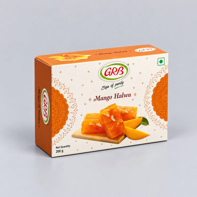 A 200g box of GRB Mango Halwa on a light gray background. The packaging features a warm orange and cream design with an illustration of mango slices and almonds.