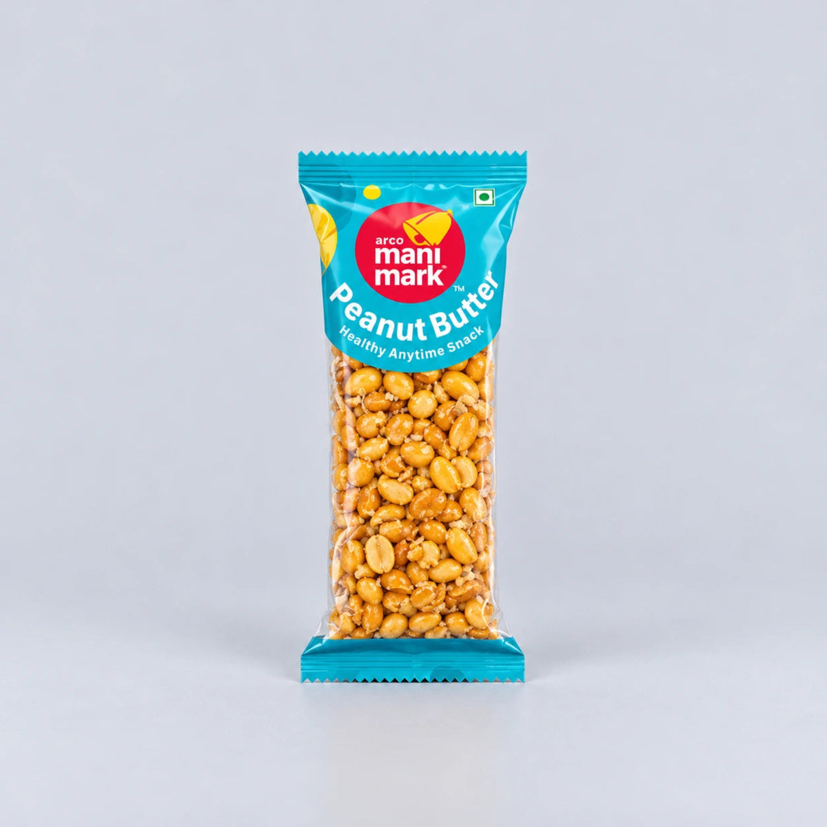 A package of Mantri Mark Peanut Butter, featuring golden-brown roasted peanuts in a clear bag with a bright teal and red label, set against a plain light gray background.