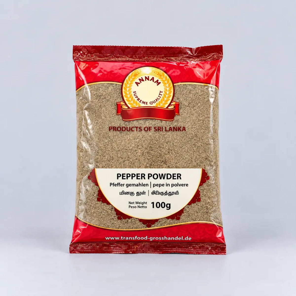 A 100g package of Annam Gourmet Pepper Powder, featuring a red and beige packaging design with a clear window showing the brownish-beige ground pepper inside, set against a light gray background.