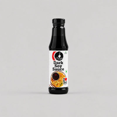 A bottle of Chettinad Dark Soy Sauce on a light gray background. The bottle is black with a white label featuring the Chettinad brand logo and an image of soy sauce noodles.