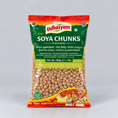 A 500g bag of Udhaiyam Mini Soya Chunks, featuring a green and red packaging design with illustrations of a farmer and cow, set against a plain light gray background.