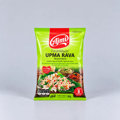 A 1 kg bag of Ajmi FreshMade UPMA RAVA Roasted Rava, featuring a bright green packaging with a red brand logo and food photography at the bottom, set against a neutral gray background.