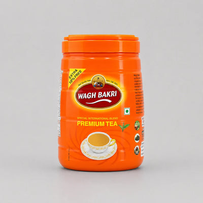 A bright orange plastic jar of Wagh Bakri Premium Tea on a light gray background.