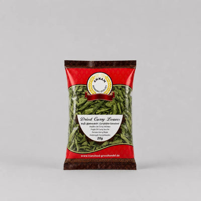 Packaged dried curry leaves with a red label on a gray background