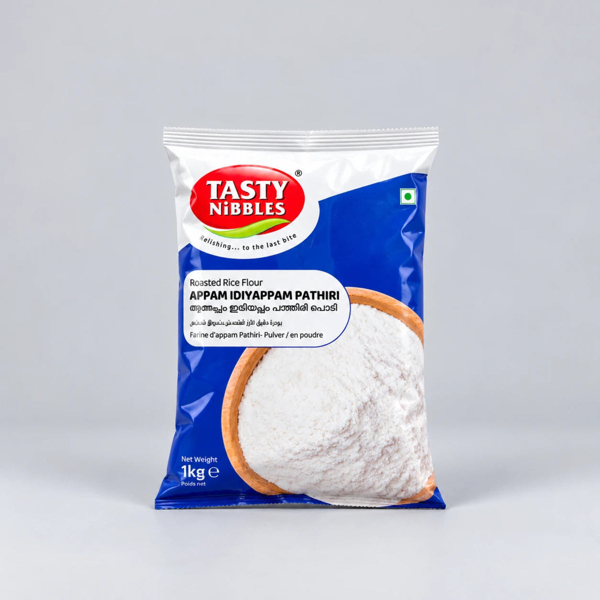 A 1 kg bag of Tasty Nibbles Appam (Iyyappam Pathiri) roasted rice flour, featuring a blue and white packaging design with a red logo and an illustration of a crispy fried appam.