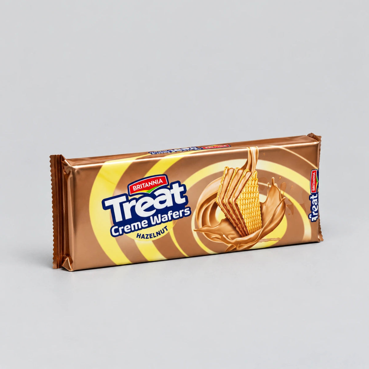 A single wrapped bar of Britainia Treat Creme Wafers (Hazelnut) on a neutral light gray background.
