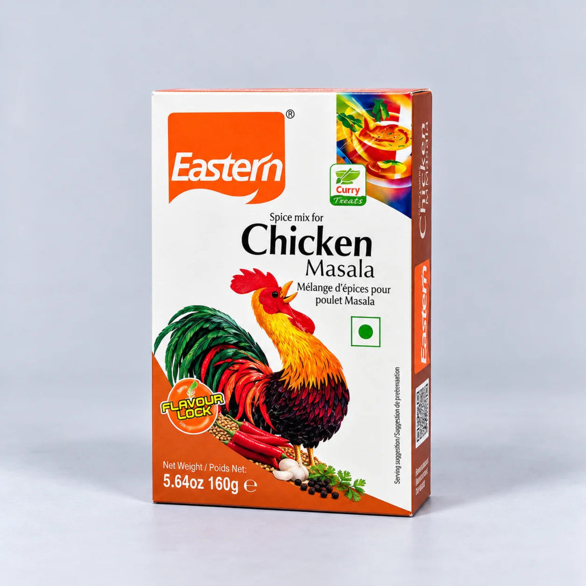 A box of Eastern Chicken Masala spice mix, featuring a white and orange packaging design with a colorful rooster illustration, photographed on a neutral light gray background.