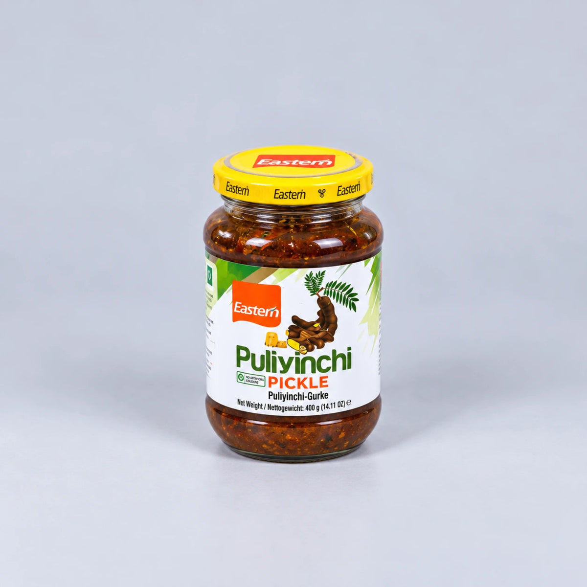 A glass jar of Eastern brand Pulivinchi Pickle with a yellow lid, set against a plain light gray background.