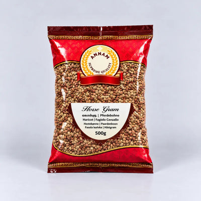 A 500g bag of Annam Supreme Quality Horse Gram (fava beans) in a red and gold packaging with a clear window showing the brown gram beans inside, set against a light gray background.