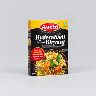 Aachi Hyderabad Basmati Biryan Kit in a rectangular cardboard box, shown on a light gray background. The packaging is primarily black with a yellow top banner, a red brand logo, and a photo of prepared biryani rice on the front.