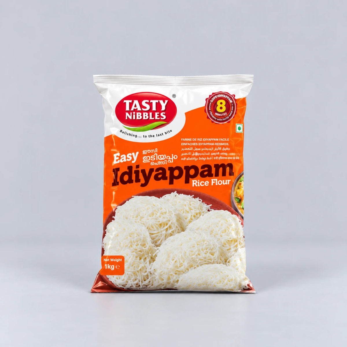 A 1 kg bag of Tasty Nibbles Idiyappam Rice Flour, featuring an orange and white packaging design with a photo of the cooked rice flour noodles on a light gray background.