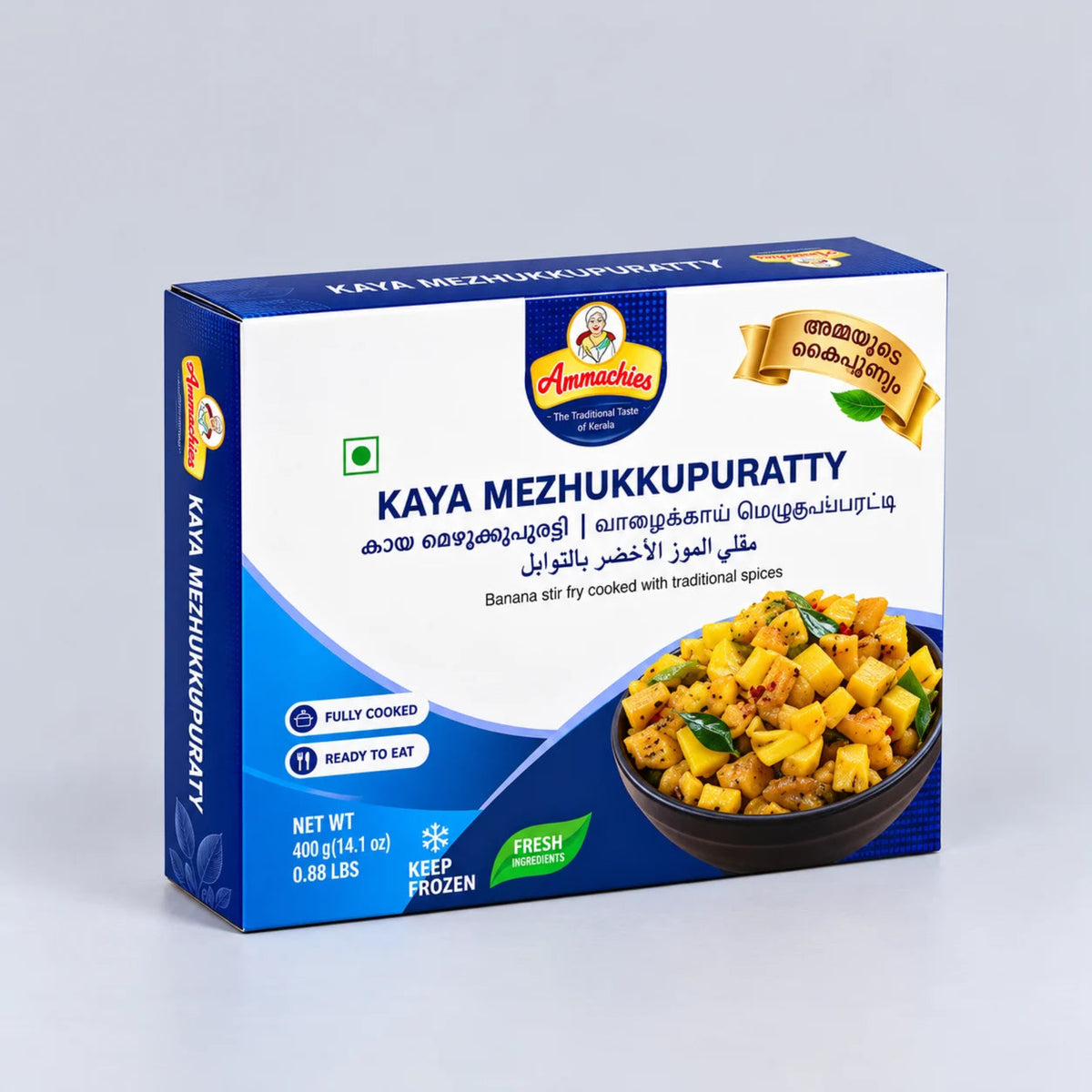 A boxed food product labeled Annamich's Kaya Mezhukkupuratty, shown standing upright on a light gray studio background. The package is predominantly white and blue with a photo of the prepared curry on the front and product details including net weight and ready-to-eat icons.