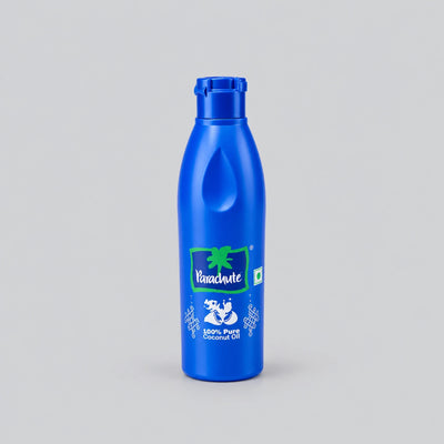 A blue plastic bottle of Vanihande Coconut Oil with a matching blue cap, centered on a light gray background.