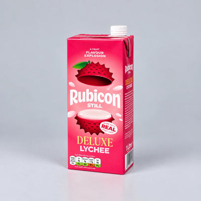 A 1.25L carton of Rubicon Still Deluxe Lychee juice, featuring a vibrant pink design with illustrations of lychees and white text, set against a neutral gray background.