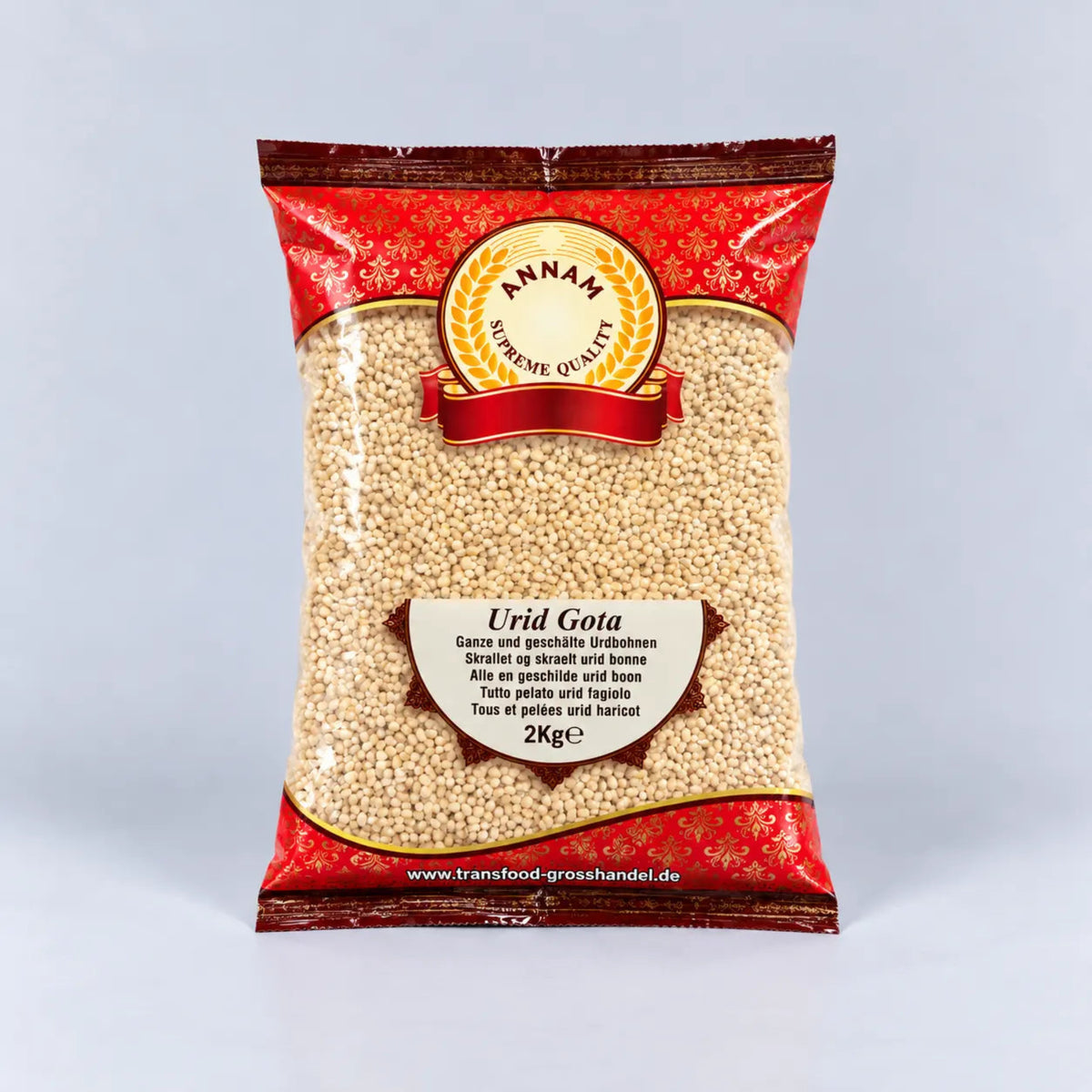 A 2kg bag of Annam Urid Gota whole spices, featuring a red patterned packaging with a clear window showing the light beige whole spices inside, set against a light gray background.